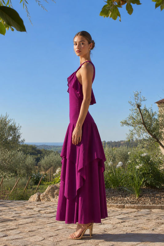 Side profile view of fuchsia maxi dress in outdoor setting