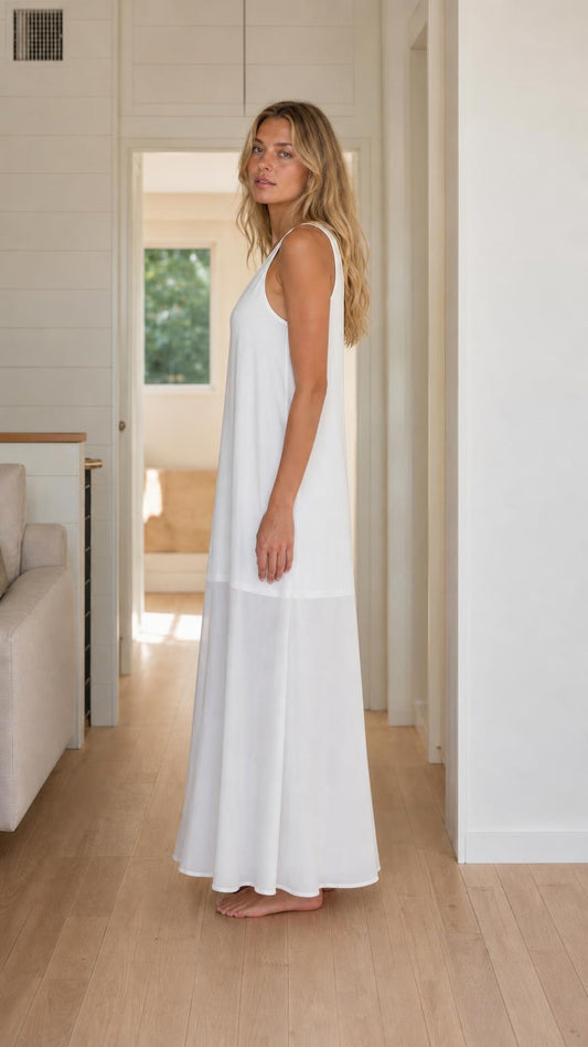 Side view of woman wearing white sleeveless maxi dress