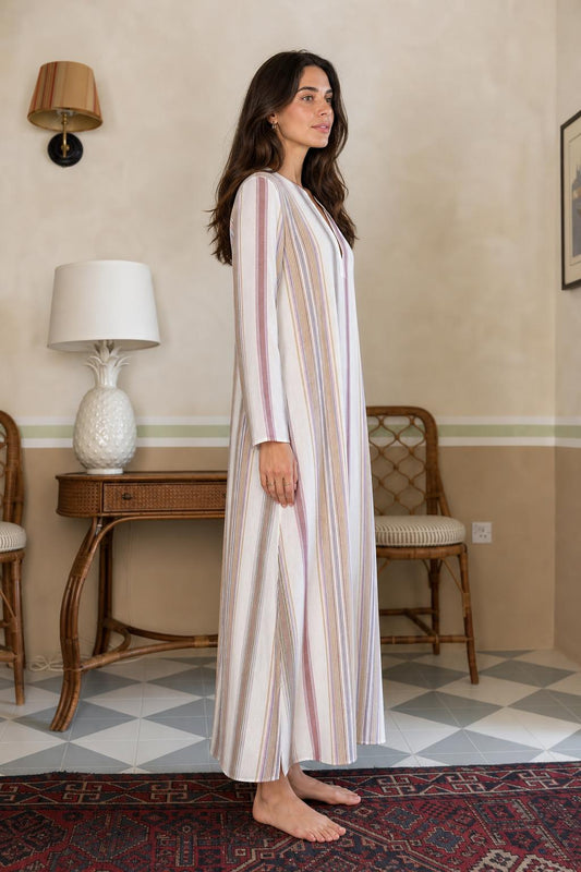 Side view of model wearing multi-stripe long sleeve maxi dress