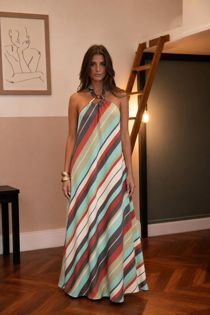 Front view of woman wearing multi-color striped halter maxi dress