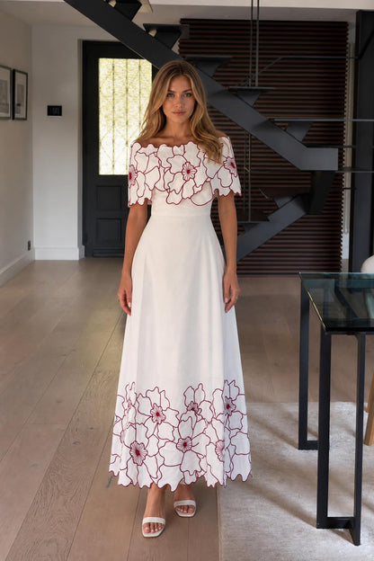 Front view of white off-the-shoulder floral embroidered maxi dress