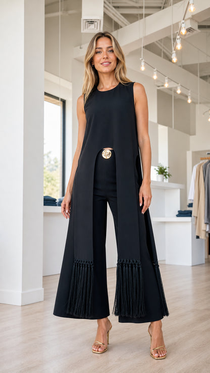 Model wearing black sleeveless tunic and fringe hem pants set, front view