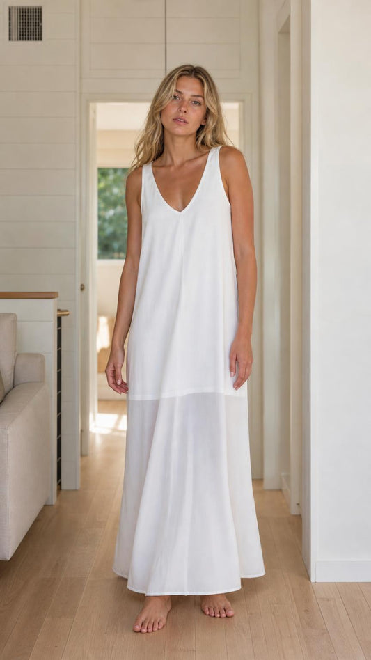 Front view of woman wearing white sleeveless maxi dress