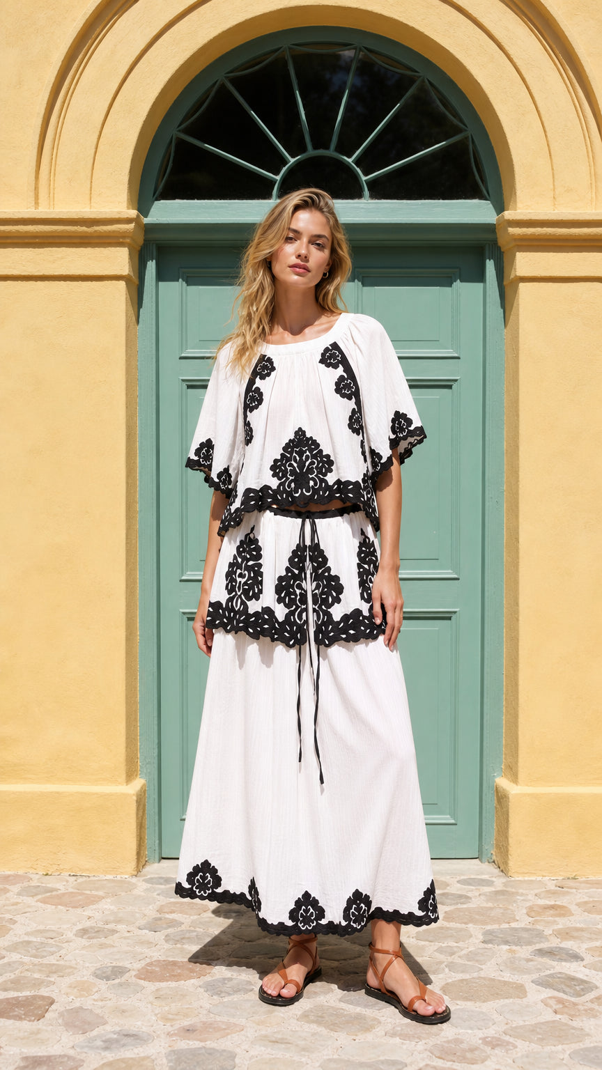 Front view of model wearing white boho embroidered two-piece maxi set