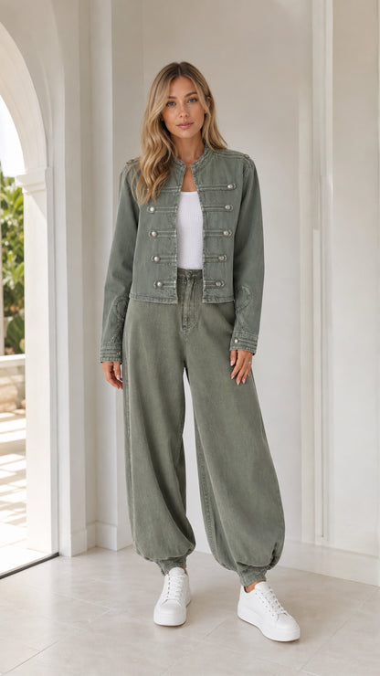 Front full view of woman wearing sage green utility jacket and matching balloon pants