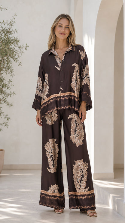 Front view of model wearing brown satin paisley print lounge set