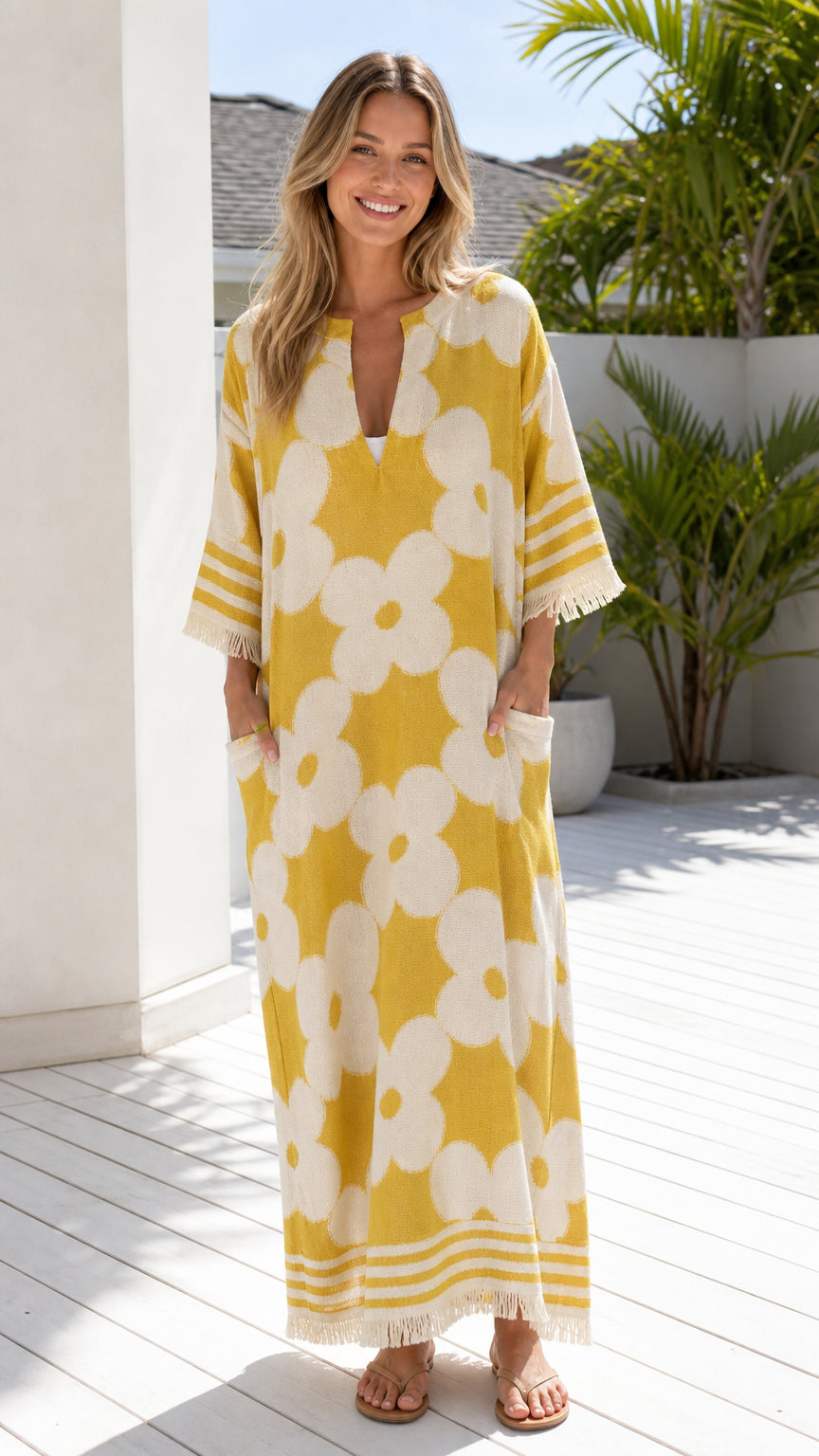 Front view of woman wearing yellow floral jacquard maxi dress