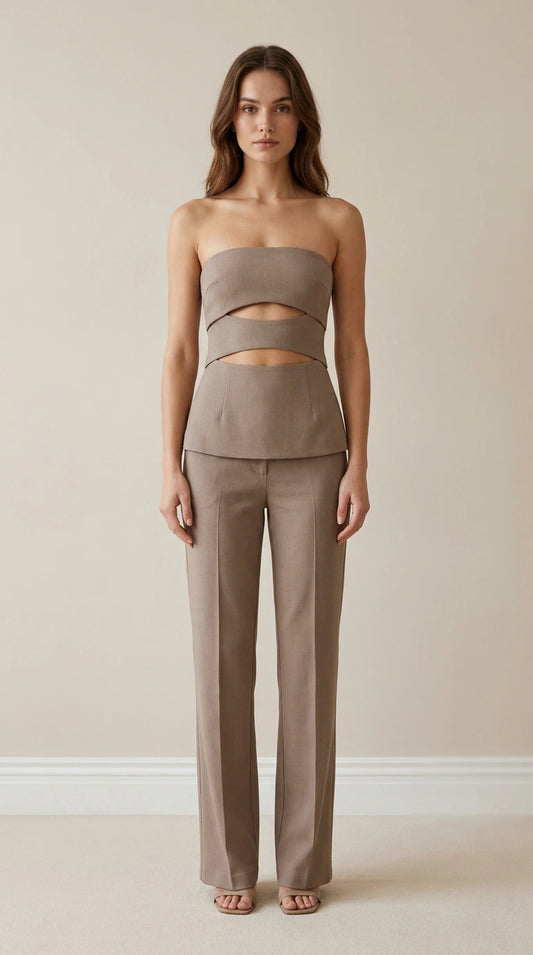 Front view of model wearing taupe strapless cut-out top and trousers set