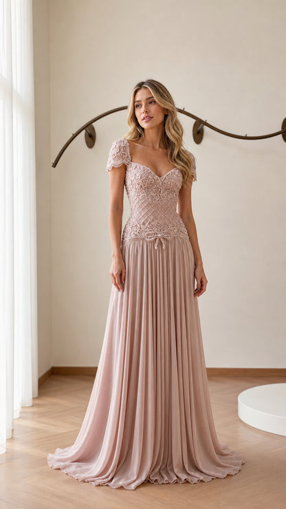 Front view of model wearing blush pink beaded chiffon evening gown