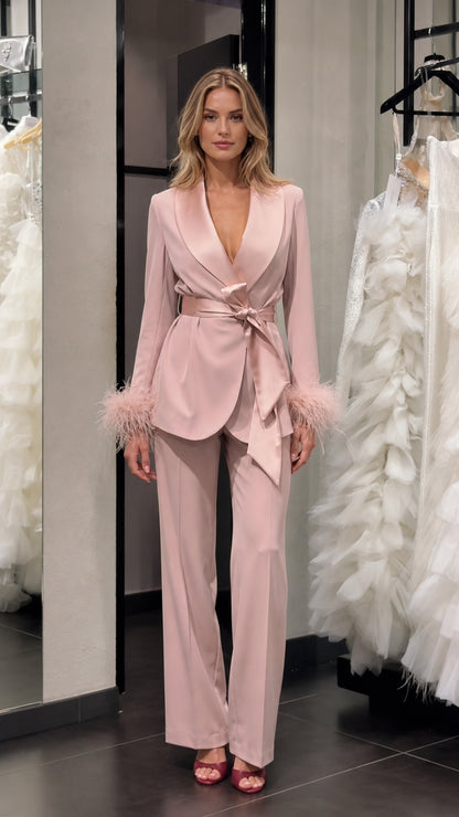 Model wearing pink satin feather cuff blazer and trousers set front view