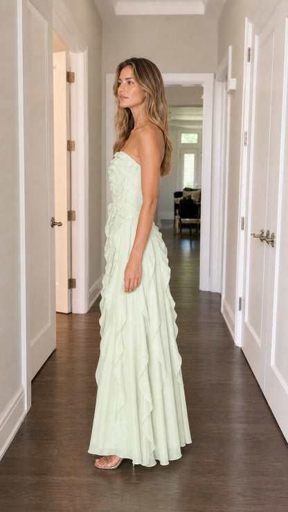 Side profile of model in sage green ruffle maxi dress