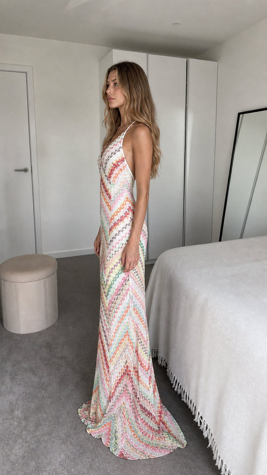 Side view of model wearing white chevron maxi dress