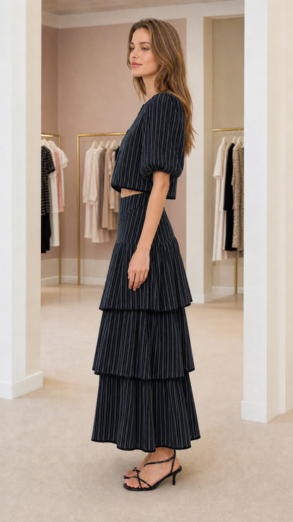Side view of model wearing black pinstripe matching set