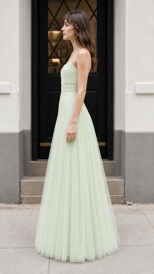 Side profile of model in sage green evening gown