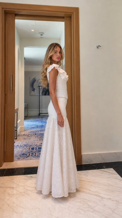 Model wearing white lace matching set, side profile view