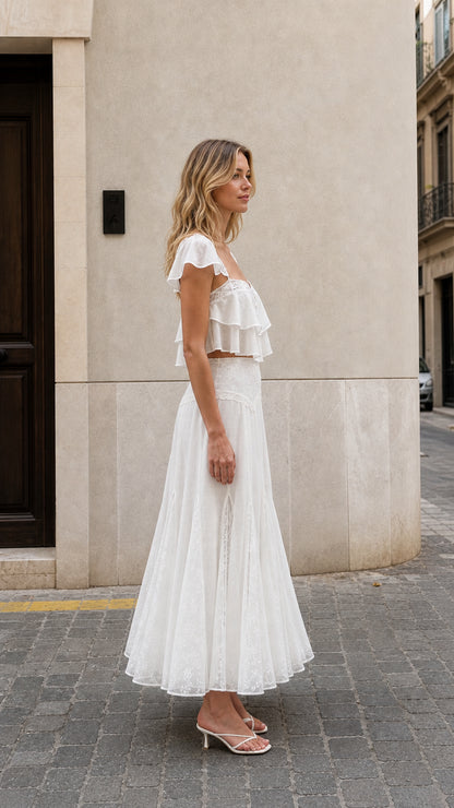 Side view of woman wearing white ruffled two-piece maxi set
