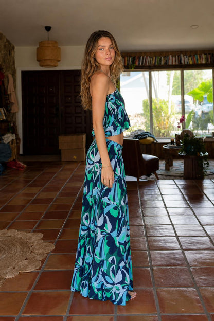 Side view of model wearing blue tropical print two-piece set