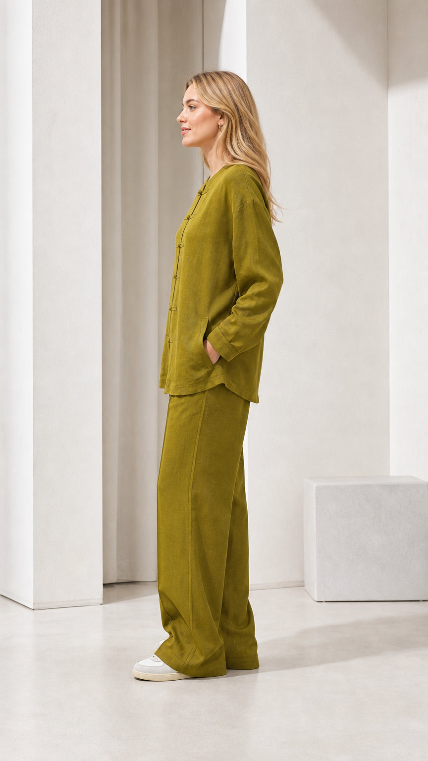 Model wearing olive green linen-blend two-piece set, side view