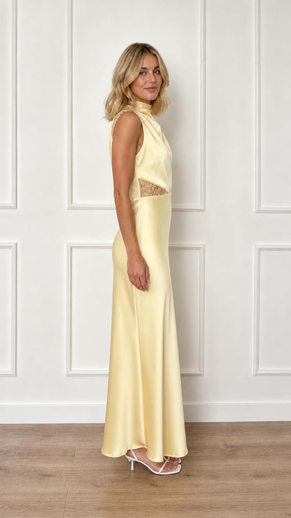 Side view of yellow satin maxi dress on model