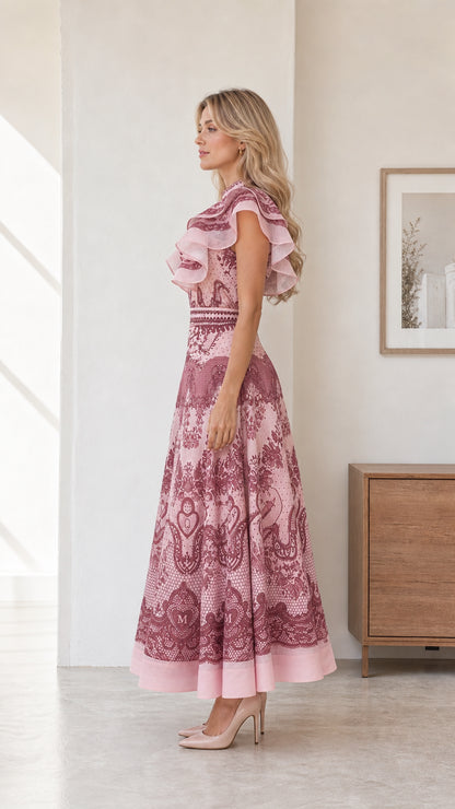 Side profile view of model in pink midi dress