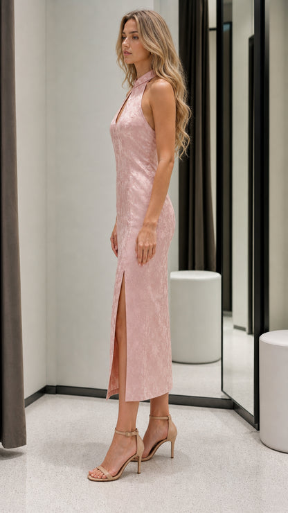 Side profile view of pink midi dress with high slit