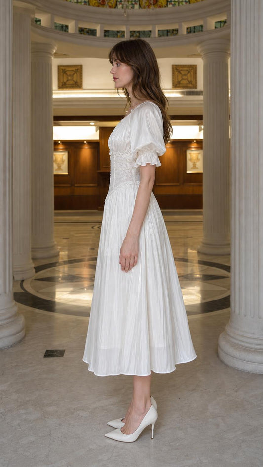 Side profile view of white midi dress
