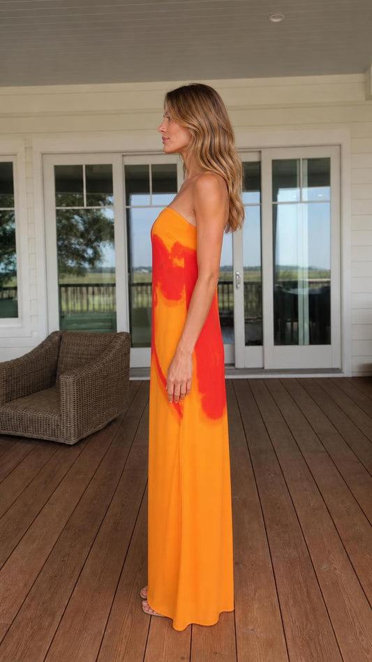Side view of woman in orange maxi dress