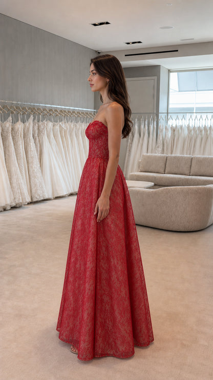 Side profile view of red strapless lace evening gown