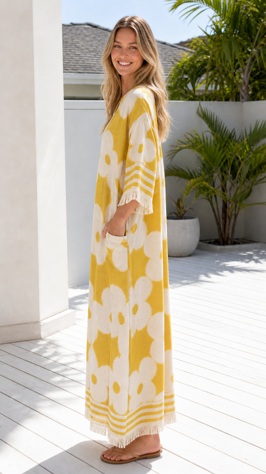 Side profile of woman in yellow floral maxi dress
