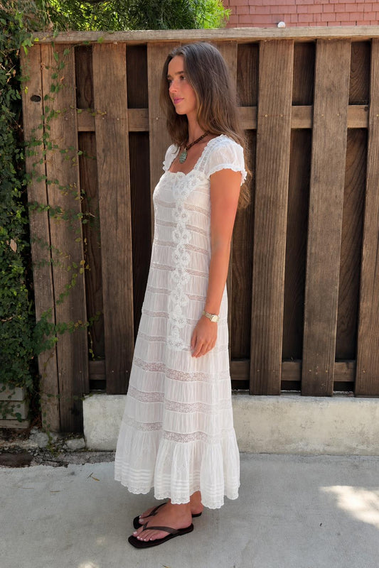Side profile view of white lace maxi dress