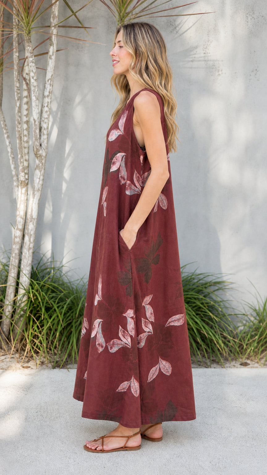 Side view of burgundy leaf print jumpsuit