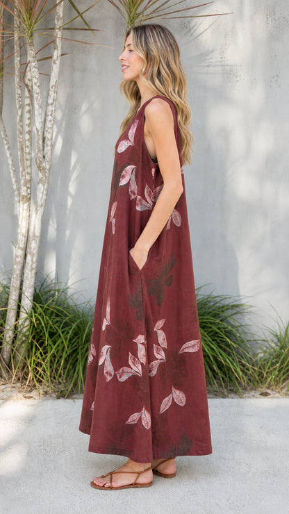 Side view of burgundy leaf print jumpsuit