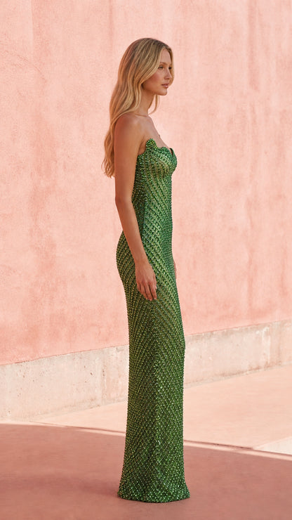 Side profile of model in sage green formal dress