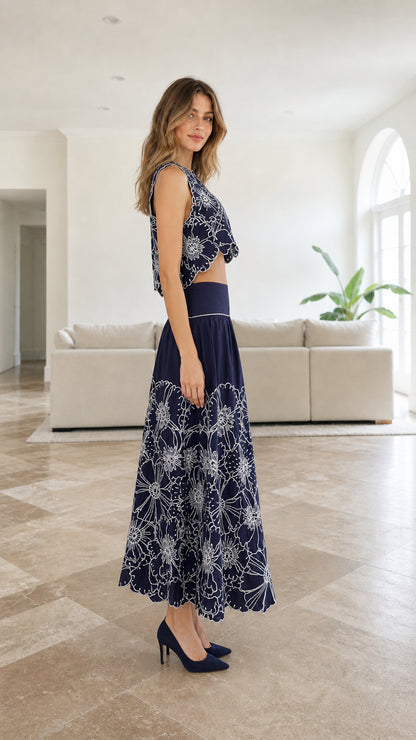 Side profile of model in navy embroidered two-piece set