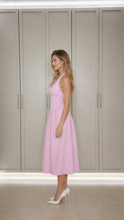 Side profile of model in pink gingham midi dress