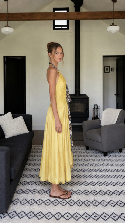 Side profile of woman in yellow maxi dress
