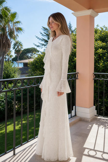 Side profile of woman wearing white long sleeve lace maxi dress