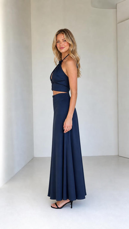 Side profile of model wearing navy two-piece satin set