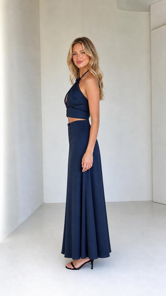 Side profile of model wearing navy two-piece satin set