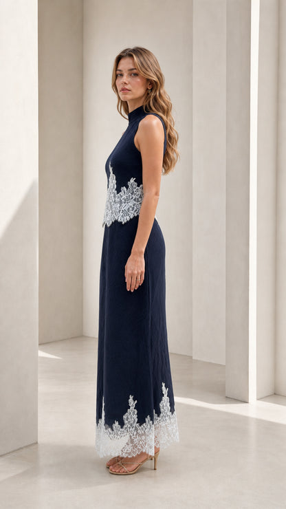 Model wearing navy mock neck lace trim maxi dress, side view