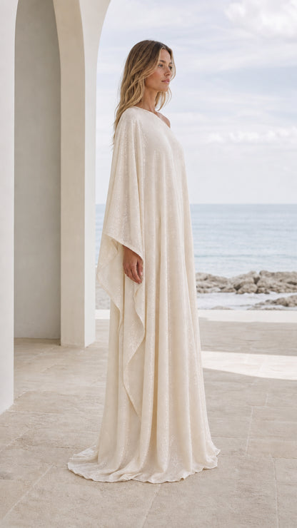 Side profile view of champagne kaftan dress showing flowing silhouette