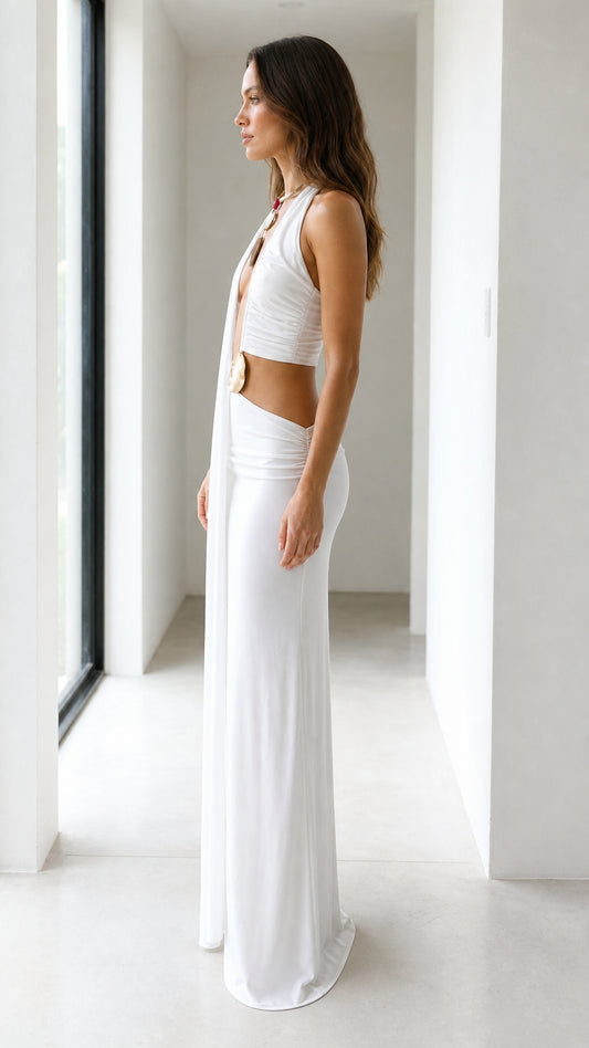 Side profile view of white drape maxi dress