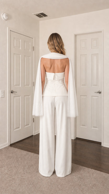 Back view of model in white strapless top and trousers