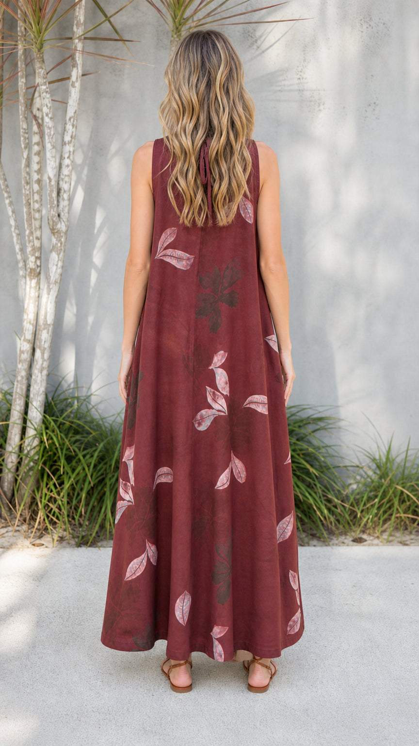 Back view of burgundy jumpsuit showing tie-back detail
