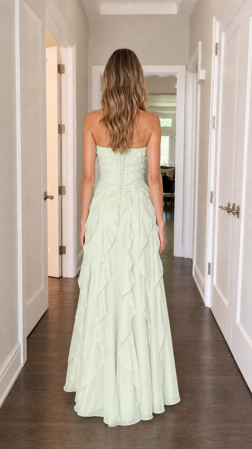 Back view of model in sage green strapless evening gown