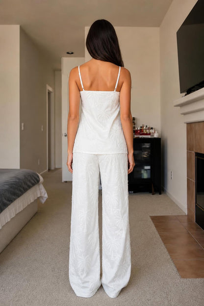 Back view of woman in white palm embroidered lounge set