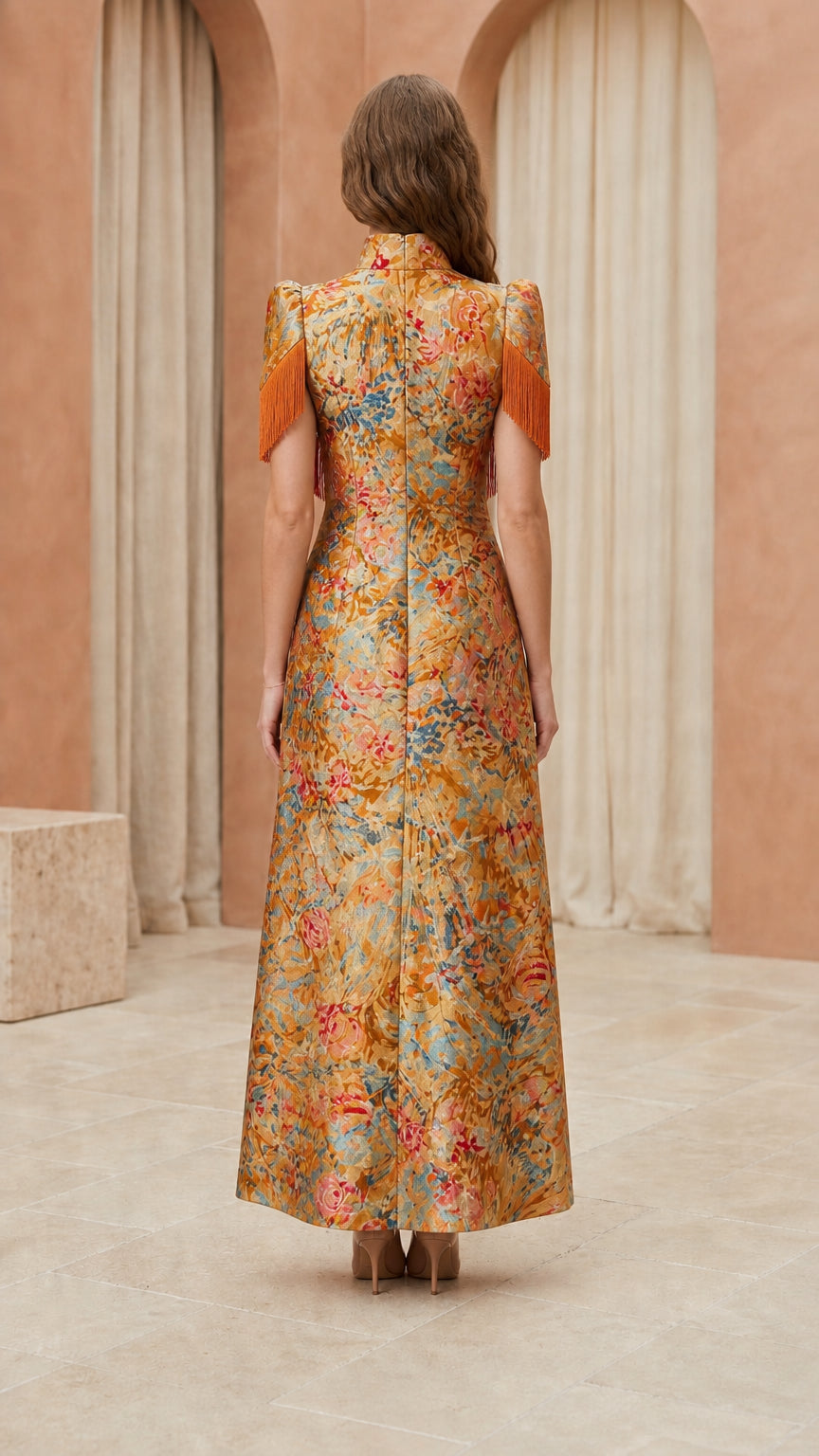 Back view of model showcasing structured back of gold brocade gown