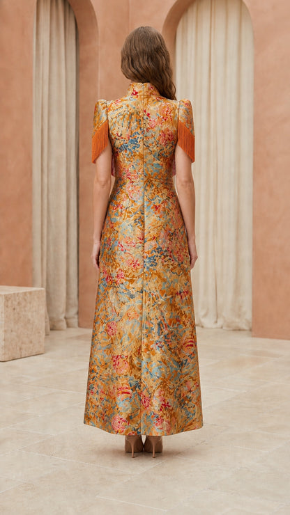 Back view of model showcasing structured back of gold brocade gown