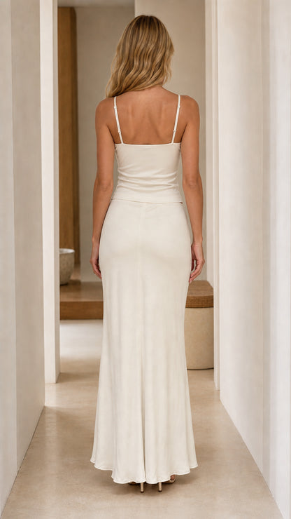 Back view of model in white two-piece maxi set