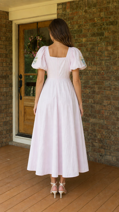 Back view of woman wearing pink square neck midi dress